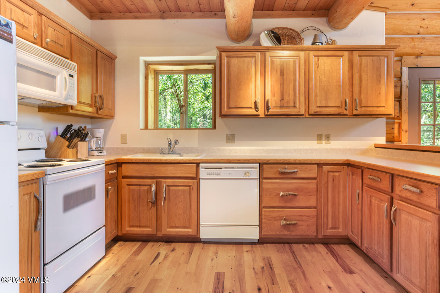 150 County Road Gypsum, CO 81637 - Photo 26 of 43 a kitchen with stainless steel appliances granite countertop a sink a stove cabinets and wooden floor