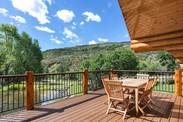 a patio with wooden floor and outdoor seating