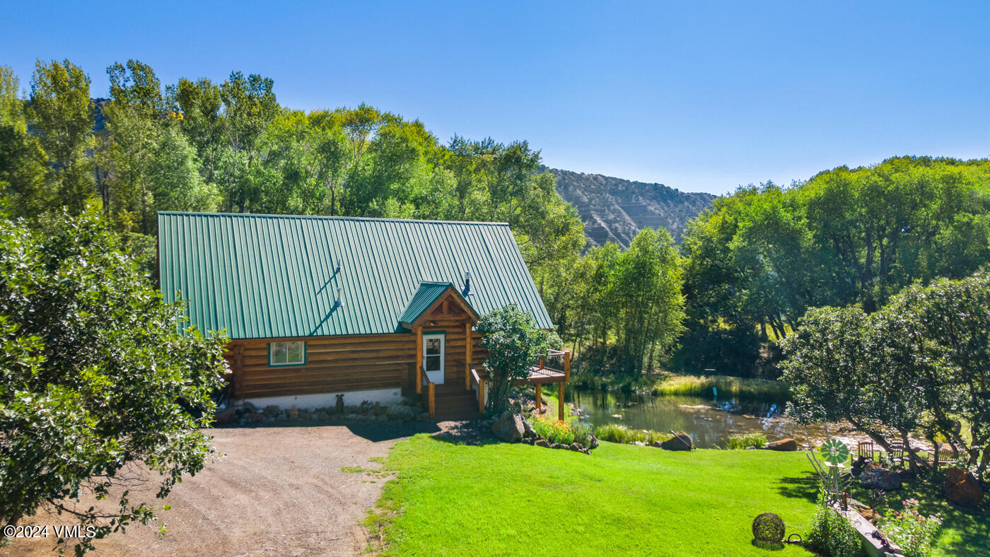 150 County Road Gypsum, CO 81637 - Photo 7 of 43 a view of a back yard with a wooden fence