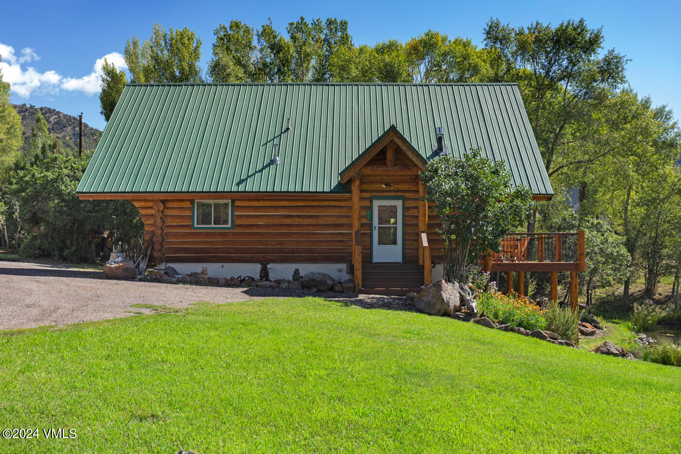 150 County Road Gypsum, CO 81637 - Photo 8 of 43 a green field with trees in the background