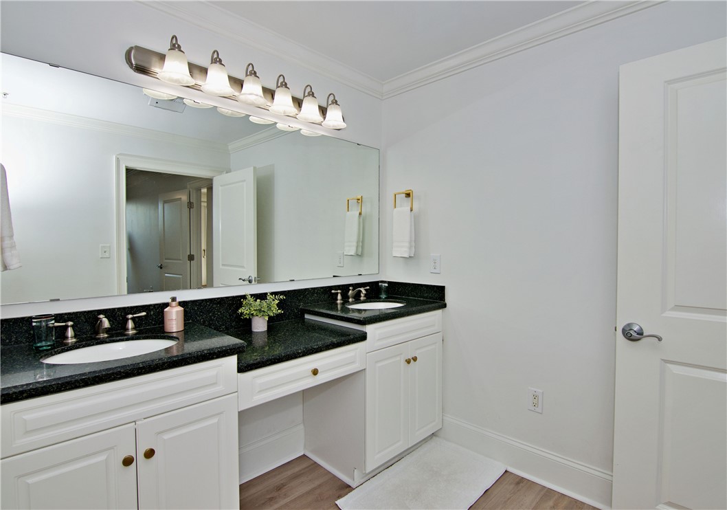 601 Watermarke Lane Anderson, SC 29625 - Photo 10 of 25 This bright bathroom offers dual vanities with dark countertops and classic white cabinetry.