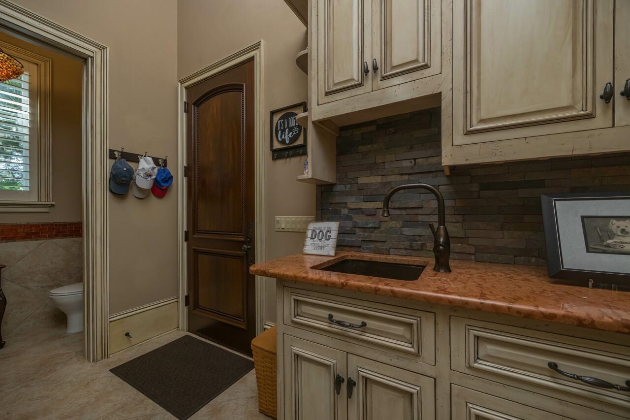 924 Ocean Palm Way St. Augustine, FL 32080 - Photo 31 of 81 a kitchen with a refrigerator and cabinets