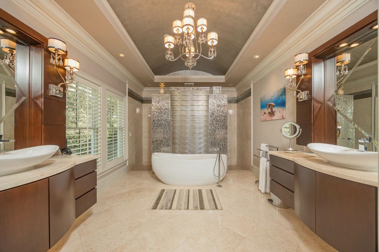 924 Ocean Palm Way St. Augustine, FL 32080 - Photo 35 of 81 a spacious bathroom with a sink a large mirror and a bathtub