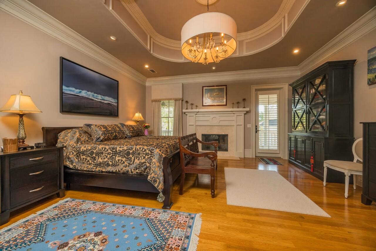 924 Ocean Palm Way St. Augustine, FL 32080 - Photo 36 of 81 a bedroom with a bed and a chandelier