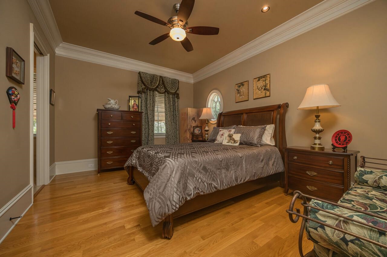 924 Ocean Palm Way St. Augustine, FL 32080 - Photo 47 of 81 a bedroom with a bed and a chandelier
