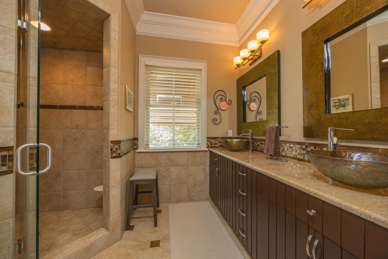 924 Ocean Palm Way St. Augustine, FL 32080 - Photo 50 of 81 a bathroom with a granite countertop sink mirror and double