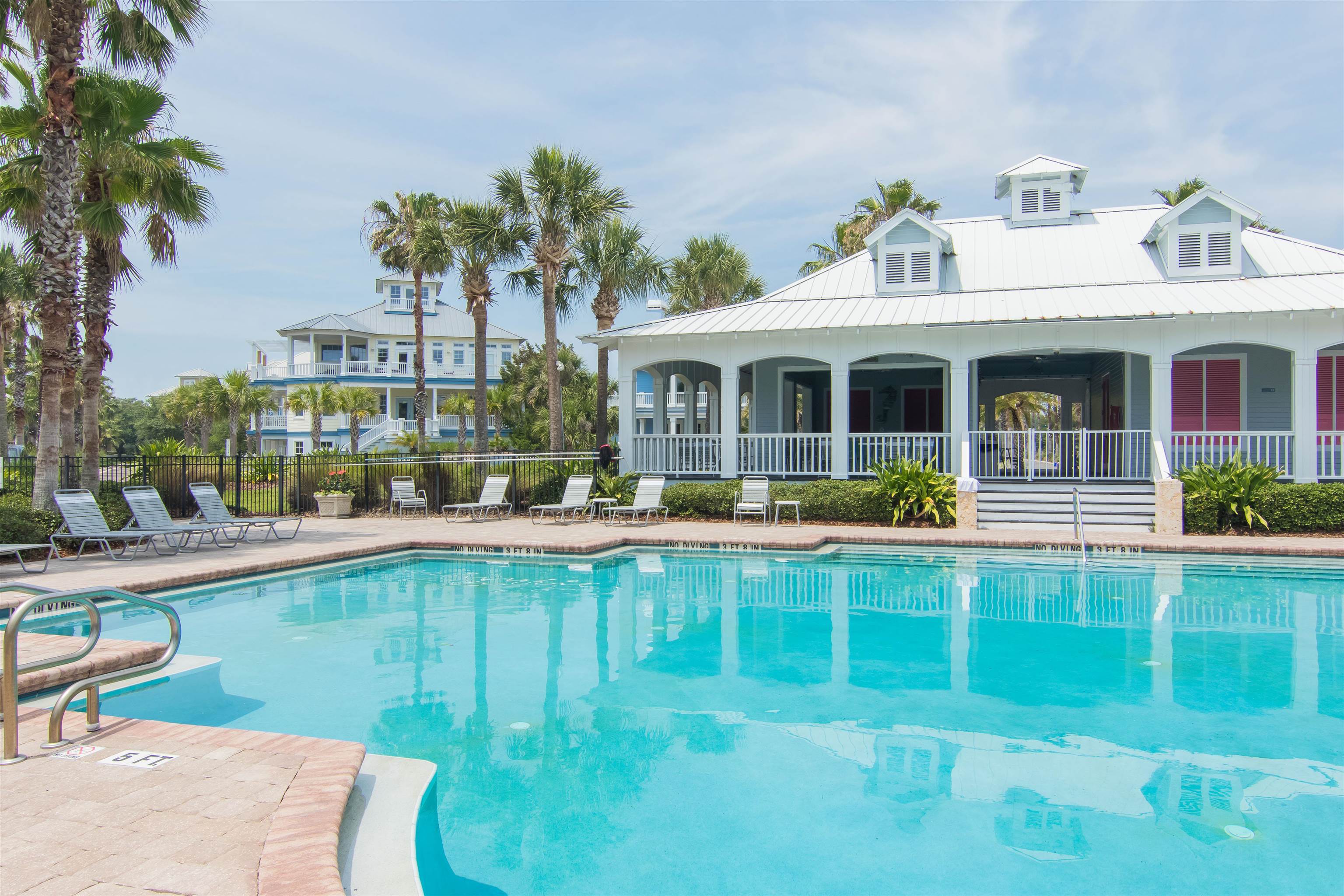 924 Ocean Palm Way St. Augustine, FL 32080 - Photo 76 of 81 a view of a house with a swimming pool and a chairs and table in a patio