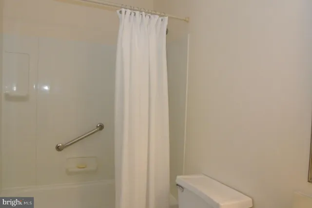 a bathroom with a shower and a toilet