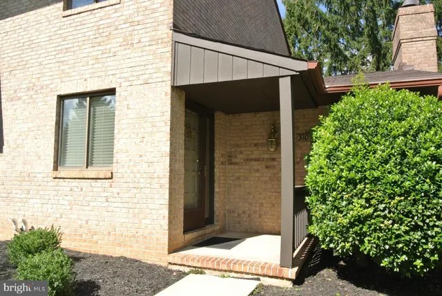 a view of house with potted plants