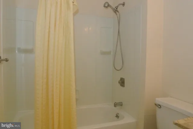 a view of empty room with floor to ceiling window and an entrance