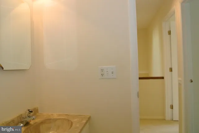 an empty room with wooden floor and closet area