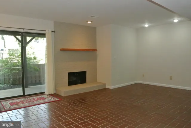 an empty room with wooden floor and closet