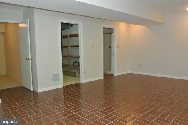 a bathroom with a toilet sink vanity and granite