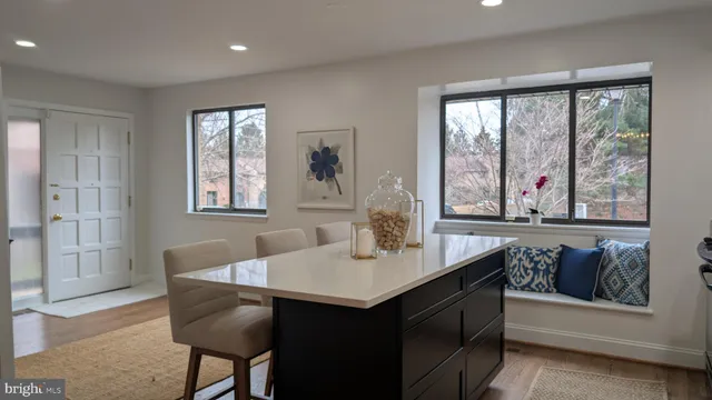 a dining room with a window and chairs