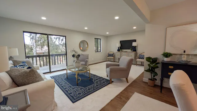 a living room with furniture and a floor to ceiling window