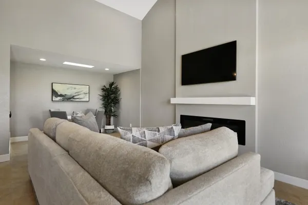 a bathroom with a granite countertop sink a toilet a mirror and shower