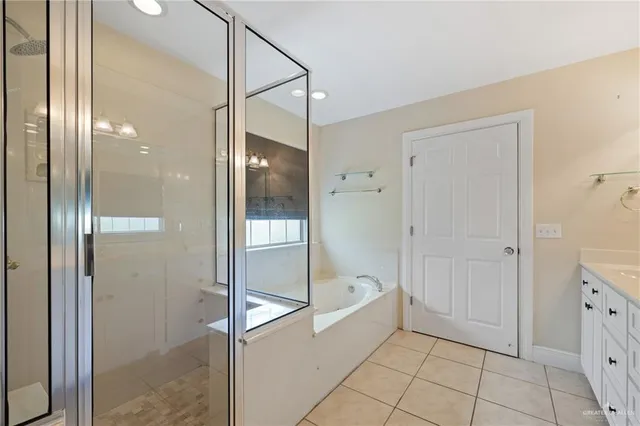 a bathroom with a tub and shower