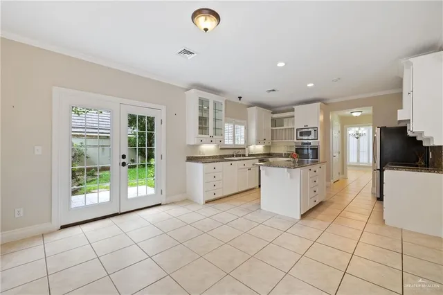 a large white kitchen with a stove a sink dishwasher and a refrigerator