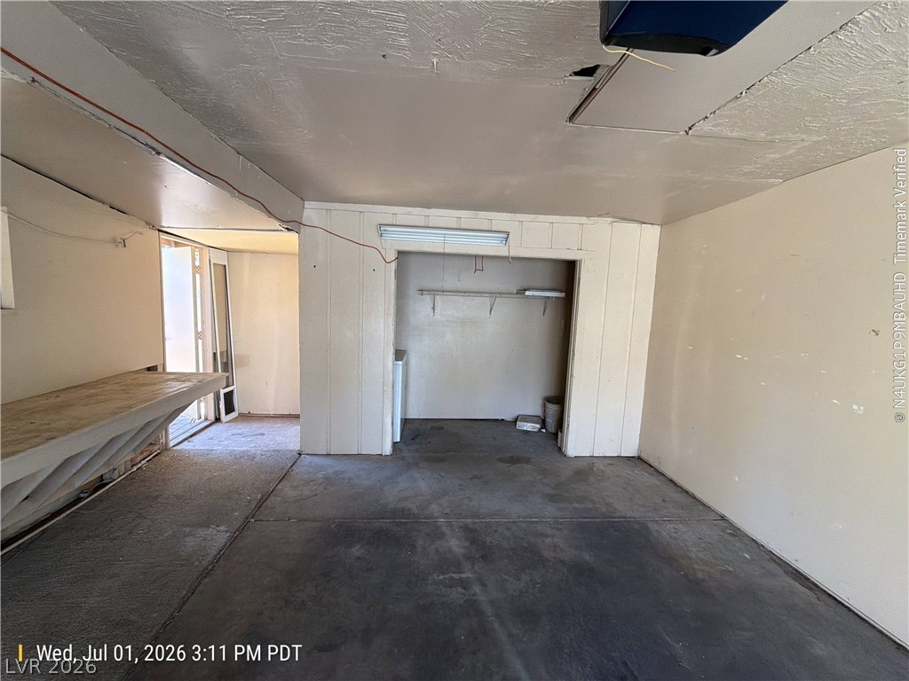2313 Ragland Street Las Vegas, NV 89108 - Photo 9 of 11 A utilitarian garage space with a dedicated laundry area and convenient outdoor access.