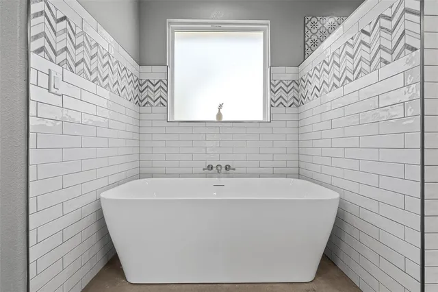 a white bath tub sitting in a bathroom