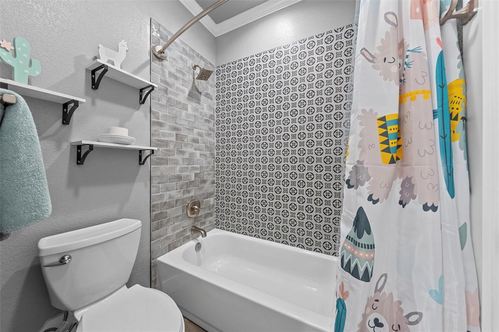 370 Rio Bonito Drive Robinson, TX 76706 - Photo 25 of 39 a bathroom with a toilet and a shower curtain