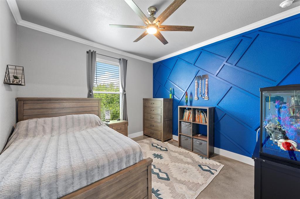 370 Rio Bonito Drive Robinson, TX 76706 - Photo 27 of 39 a bedroom with a bed and a chandelier