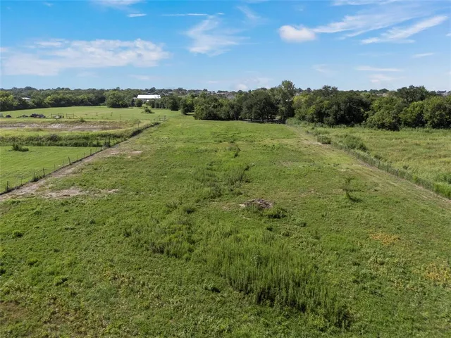a view of a field with an trees