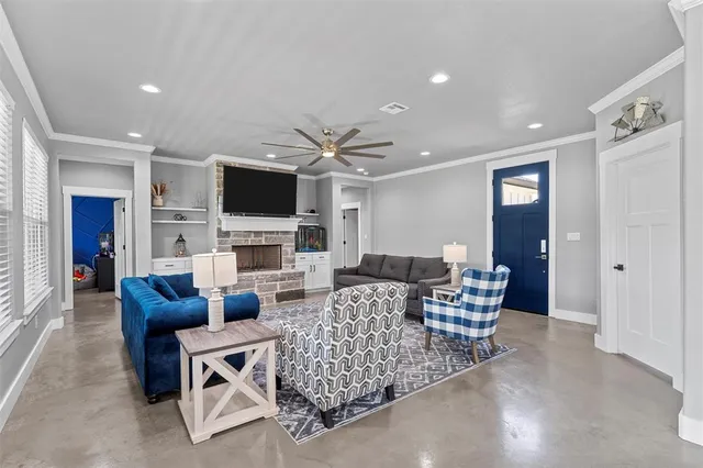 a living room with furniture a fireplace and a flat screen tv