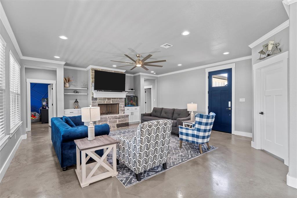 370 Rio Bonito Drive Robinson, TX 76706 - Photo 4 of 39 a living room with furniture a fireplace and a flat screen tv