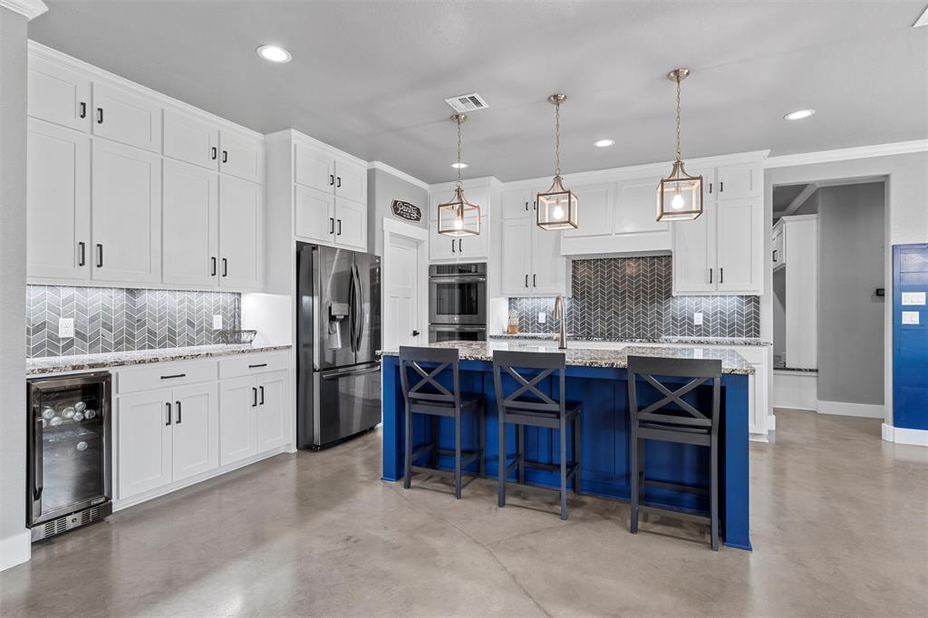 370 Rio Bonito Drive Robinson, TX 76706 - Photo 8 of 39 a large kitchen with granite countertop a sink cabinets and stainless steel appliances