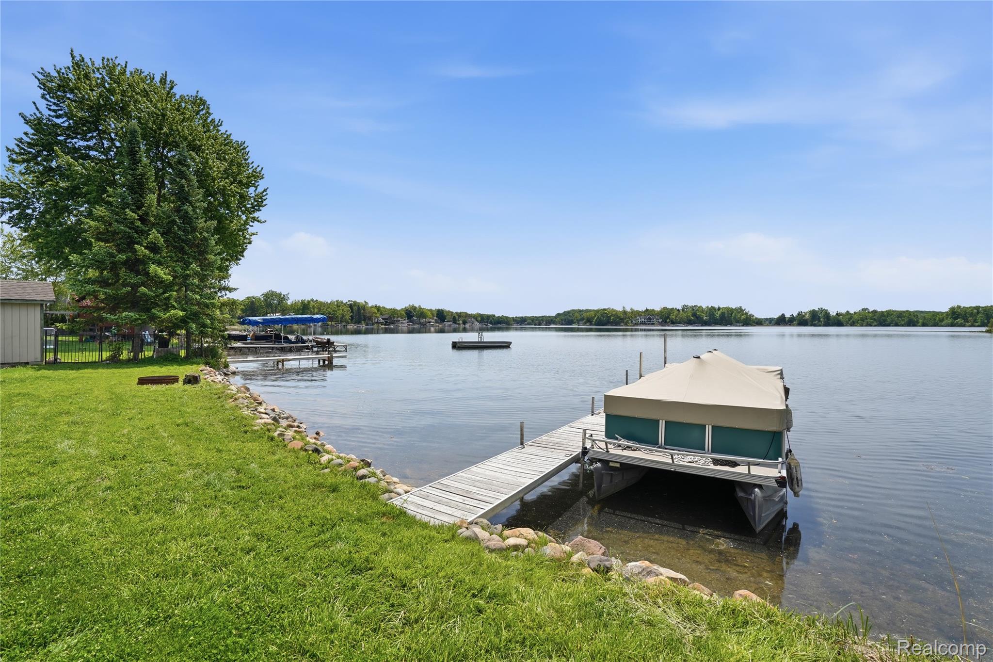 7217 Andersonville Road Clarkston, MI 48346 - Photo 50 of 65 Waterfront property featuring a private dock, boat lift, and clear lake access