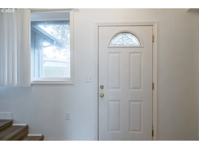 a view of an entryway with wooden floor