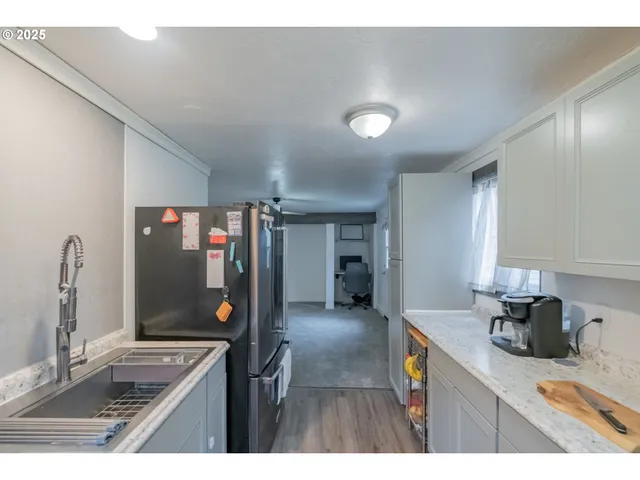 a kitchen with stainless steel appliances granite countertop a sink and cabinets