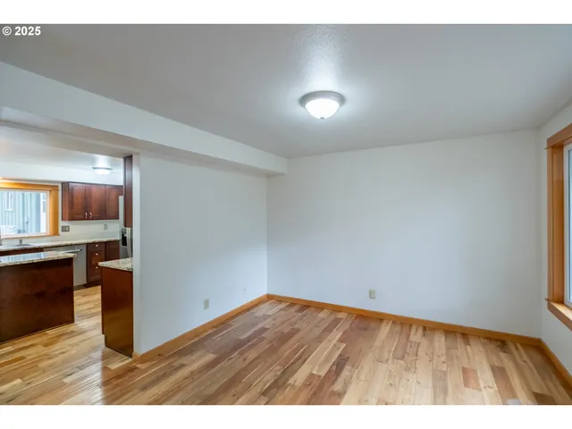 a view of kitchen and hall with wooden floor