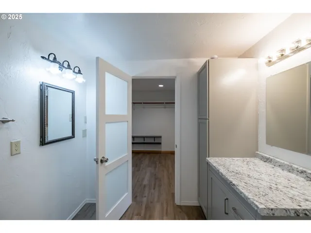 a view of bathroom with a sink mirror and shower