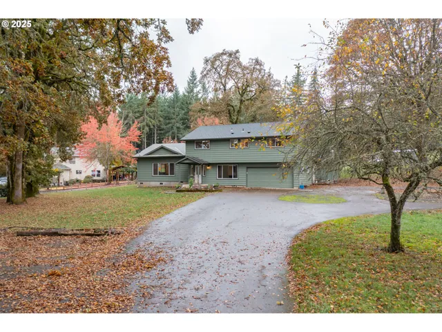 a view of a house with a yard and tree s