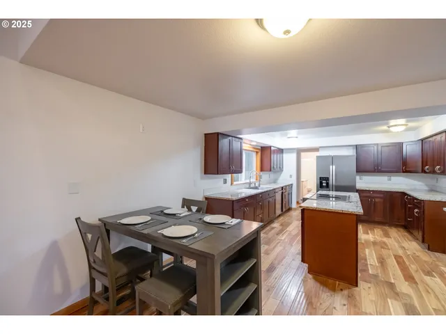 a kitchen with a table and chairs in it