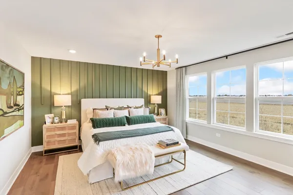 a bedroom with a large bed and a large window