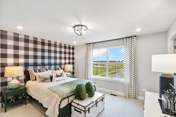 a bedroom with a bed and a lamp
