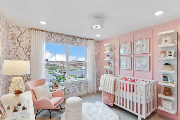 a bedroom with furniture and a large window