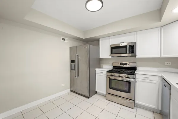 a kitchen with a stove microwave and refrigerator