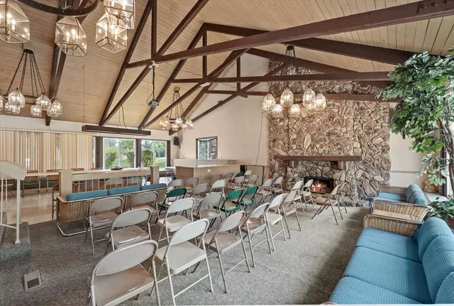 a living room with lots of furniture and a fireplace