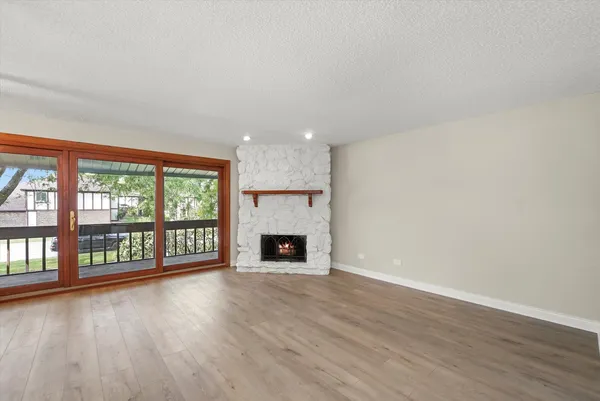 wooden floor in an empty room with a fireplace
