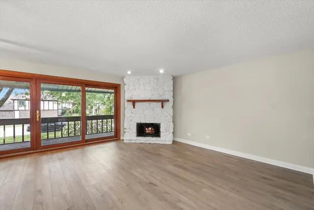 wooden floor in an empty room with a fireplace