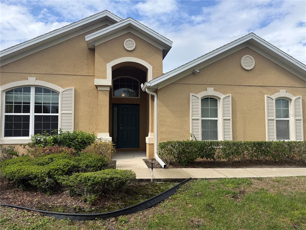 2862 Running Brook Circle Kissimmee, FL 34744 - Photo 2 of 24 a front view of a house with garden