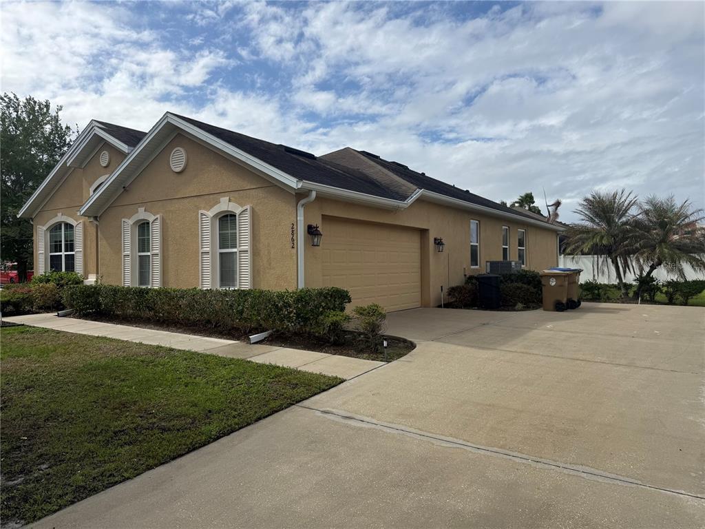 2862 Running Brook Circle Kissimmee, FL 34744 - Photo 3 of 24 a front view of a house with a yard and garage