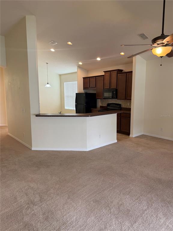 2862 Running Brook Circle Kissimmee, FL 34744 - Photo 7 of 24 a view of a kitchen with a sink and a refrigerator