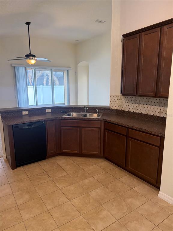2862 Running Brook Circle Kissimmee, FL 34744 - Photo 9 of 24 a kitchen with stainless steel appliances granite countertop a sink and a cabinets