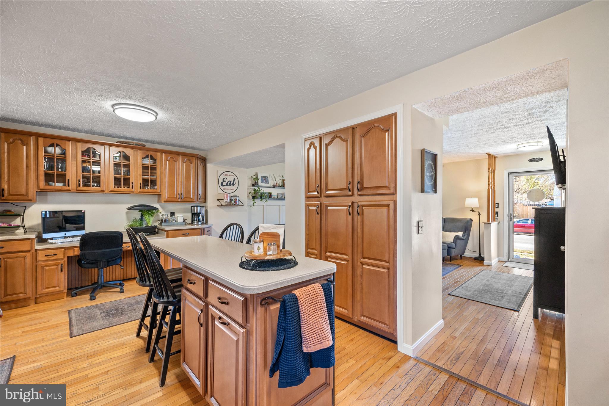 7914 Leeds Drive Pasadena, MD 21122 - Photo 1 of 49 a kitchen with stainless steel appliances granite countertop a refrigerator a stove a sink a dining table and chairs with wooden floor