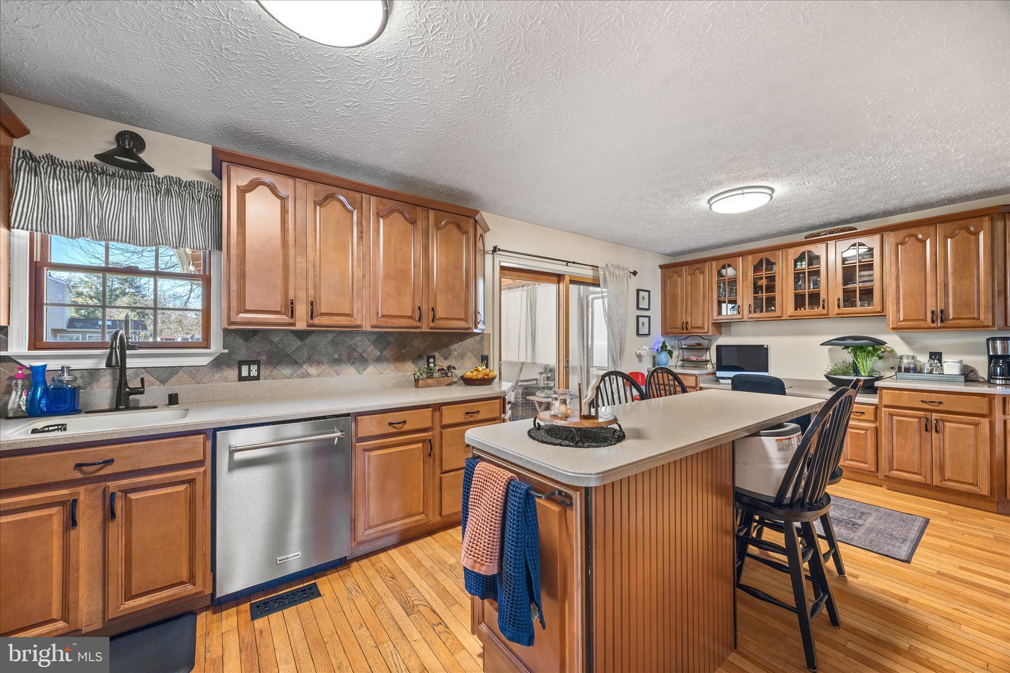 7914 Leeds Drive Pasadena, MD 21122 - Photo 2 of 49 a kitchen with a table chairs stove and cabinets